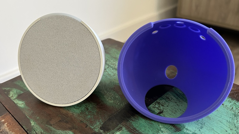 Amazon Echo Pop white alongside purple silicone sleeve