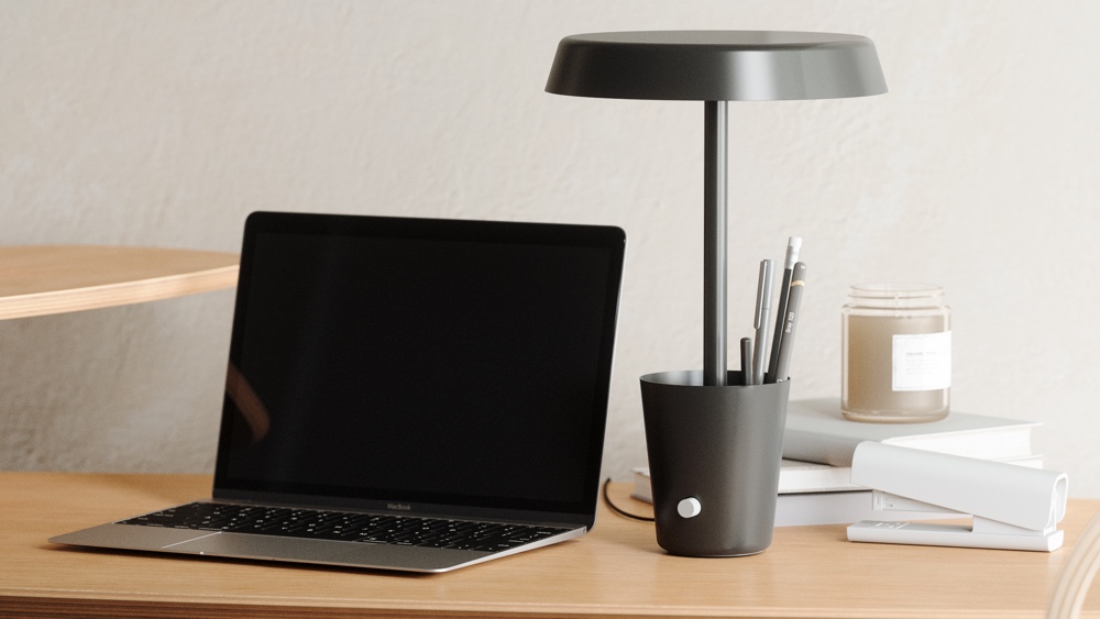 Nanoleaf cup lamp on a desk with pens